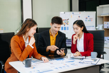 Office colleagues have a casual discussion. During a meeting in a conference room, a group of business teem