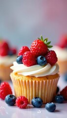 Colorful arrangement of fresh berries atop a fluffy cupcake, berries, pastries