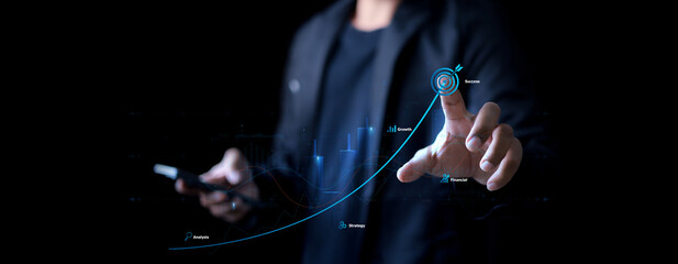 Business goal success concept, businessman touch symbol of digital marketing and target of leadership, unlock your goals with strategy, planning and goals. © phimprapha