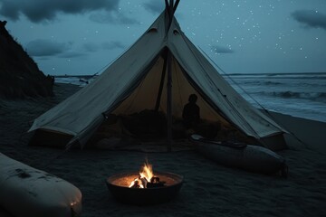 Tranquil night camping by the beach with campfire and starry sky