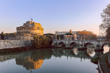 Rome in morning. Panoramic view of Castel Sant'Angelo and Bridge in Rome with reflection in Tiber...