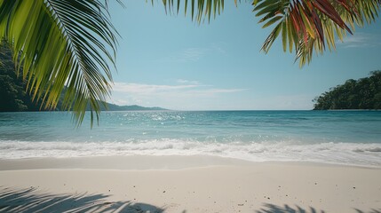 Fototapeta premium Serene Tropical Paradise with Gentle Waves on Pristine Beach under Bright Blue Sky