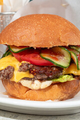 Portion of appetizing american cheeseburger on a plate