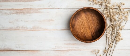 Fototapeta premium Empty Wooden Bowl Mockup on White Wood Table with Dry Flowers, Top View, Flat Lay