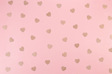 Top view of pink glitter hearts on pink background. Valentine's day, pink glitter hearts, love wallpaper. Flat lay, copy space.