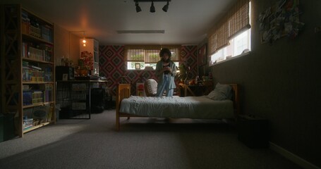 A young woman uses a mobile phone at home. She walks around the bedroom with a serious look.