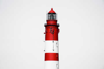 View of the red and white lighthouse on the North Frisian island of Amrum.
