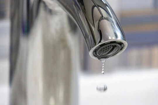 Water drips from leaky faucet