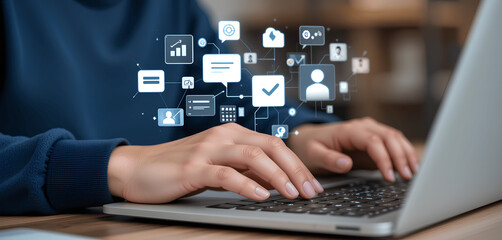 Close-up of hands typing on laptop with futuristic digital overlay of social media marketing and business network technology