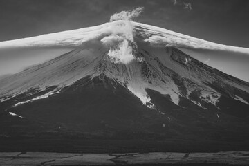 Mount fuji in black and white with clouds over the top