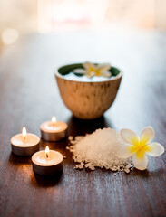 Cosmetics, spa candles or salt with flowers on table for aromatherapy treatment, self care retreat...