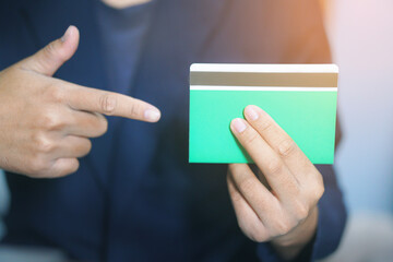 Businessman holding and pointing at a bank book, financial savings, banking concept, money management, money security, investment, future