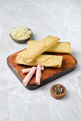 Delicious traditional tortillas served with pickled vegetables on a wooden board