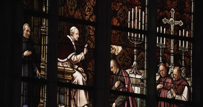 bishop and priests depicted in stained glass window in cathedral Linz