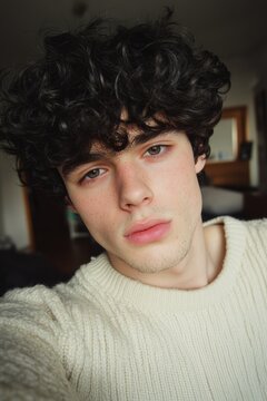 Young Man with Dark Curly Hair at Home