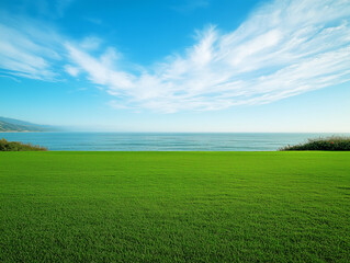 Obraz premium Bright green lawn meeting the calm ocean.