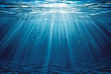 Sunbeams penetrate deep blue ocean water, creating a serene underwater scene with subtle ripples and air bubbles.