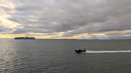 Fototapeta premium Black boat in the sea