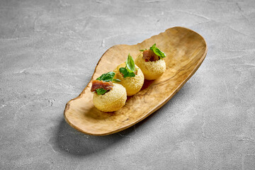A close-up of a pastry, showcasing the crispy, flaky texture of the dough and the smooth, creamy filling. The contrast between the textures creates a visually interesting image.