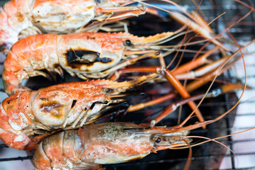 Grilled river shrimp on the flaming grill, Thai food. Big shrimps, most favorite food in Thailand