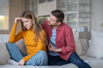 Caring guy trying to explain justify to emotional girl. Offended wife ignoring husband making...