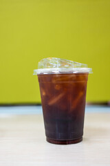 Close up glass of ice black coffee in plastic cup