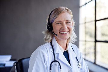 Smiling doctor with headset looking at camera