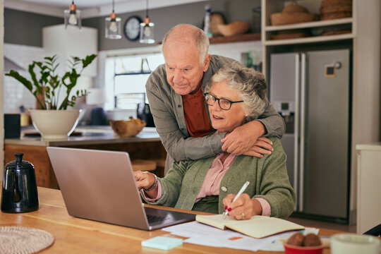 Senior couple using laptop to manage home finance - Powered by Adobe