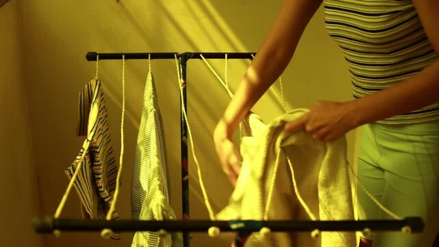 Indian young woman drying clothes
