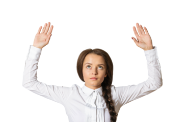 Woman in a white shirt with braided hair raising her hands up, looking upwards. Isolated on a clean white background. Concept of inquiry or surrender