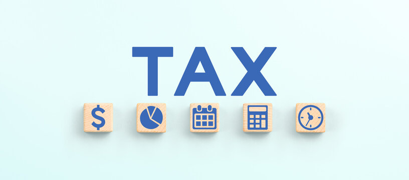 TAX icons on wooden cubes. Tax reduction planning, tax time