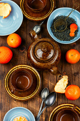 Tangerine tea in a glass teakettle.