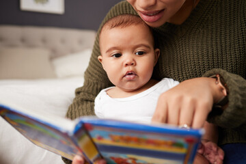 Bed, mother and reading book to baby for brain development, language skills and bonding together....