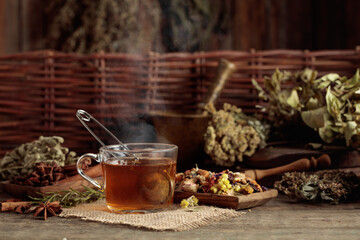Cup of herbal tea with various dried herbs, flowers, and spices.
