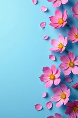 Fototapeta premium Minimalist blue background with scattered pink flowers, serene, petal, blue