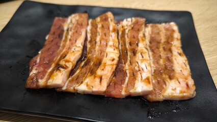 Korean style grilled beef on a black plate