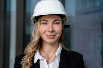 Waist up of a cute young woman in a hard cap