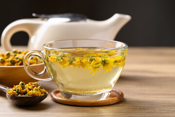 Chrysanthemum tea in cup glass with dried Chrysanthemum flowers, Healthy herbal drink
