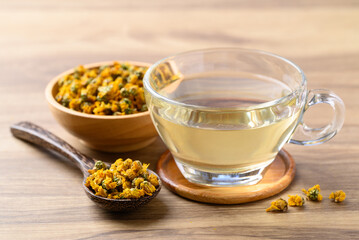 Chrysanthemum tea in cup glass with dried Chrysanthemum flowers, Healthy herbal drink