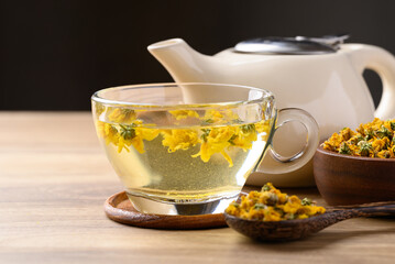 Chrysanthemum tea in cup glass with dried Chrysanthemum flowers, Healthy herbal drink