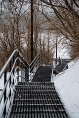 There is a beautiful set of wooden stairs that leads up a snowcovered hill, showcasing the essence...