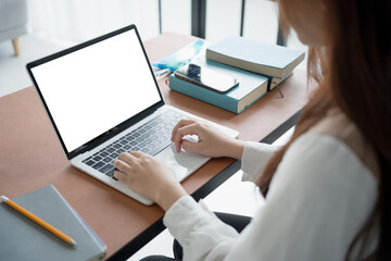 Fototapeta premium Woman using laptop with white screen on deck