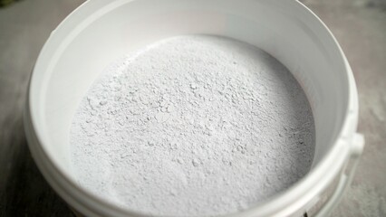 White cement powder in a bucket preparing for construction works