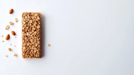 Keuken foto achterwand A plain granola bar made from mixed grains, nuts, and honey, neatly placed on a plain white background © Sinyeetew