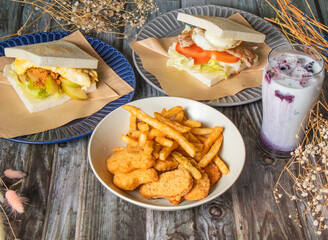 Crispy Chicken Nuggets and French Fries, Taiwanese Breakfast Sandwich, Apple pork floss egg toast, meat and egg toast, Iced Blueberry Latte served in plated side view of taiwan Brunch Platter