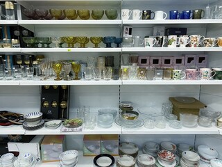 Shelves of modern stemware glasses for sale in store.Glasses and stemware set.