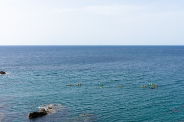 Obraz premium several kayaks in the open sea off the reefs