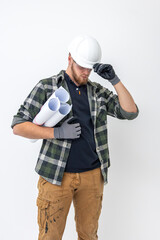 Male builder. Engineer in overalls and helmet holds blueprints and projects in his hands.