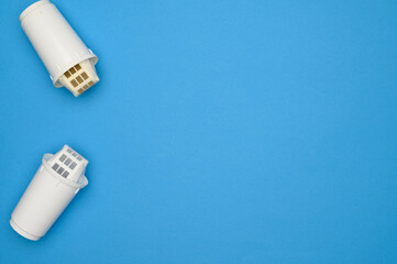 Layout dirty used replacement filter cartridge and clean filter for drinking water purification on blue background, top view. Copy space. Water pollution concept, timely replacement of water filters.