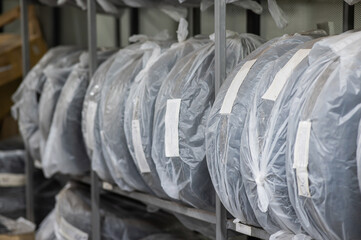 New car tires in plastic bags in a store.  © Михаил Решетников